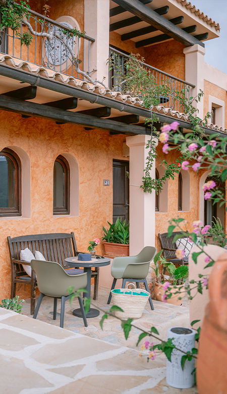 Decorative corner at Casa Naya Ibiza with a cactus in a terracotta pot and succulent plants on terracotta flooring.