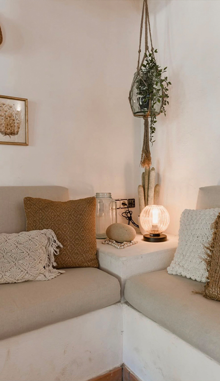 Outdoor staircase at Casa Naya Ibiza with terracotta pots and Mediterranean greenery bathed in sunlight.